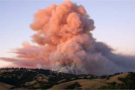 Smoke billows above Pine Ridge