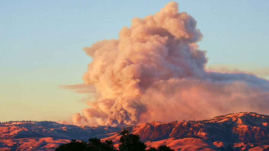 Smoke billows above Pine Ridge